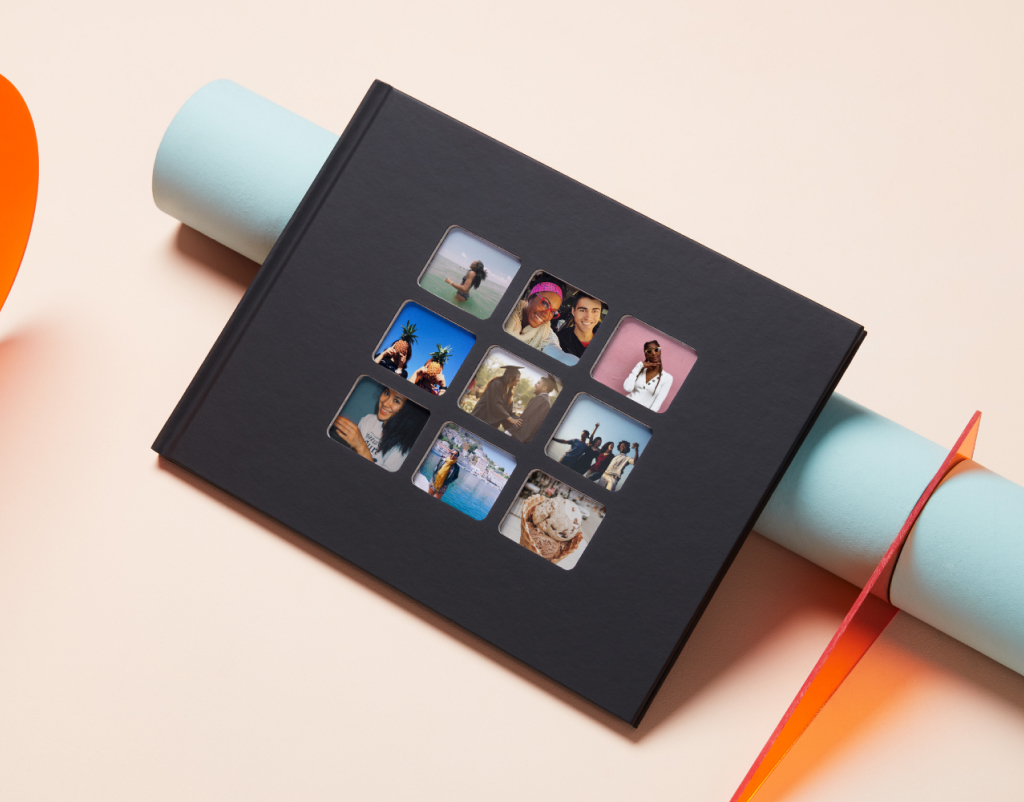 An A4 Classic Collage Photo Book with a black cover and nine window cut outs with various photos peeking through.