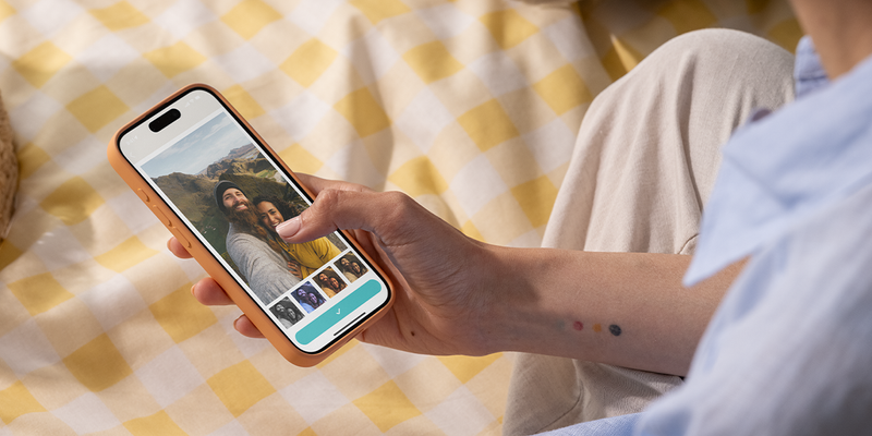 A close-up of hands using a photo filter app on a smartphone to enhance an image, discovering the best photo editing apps and free photo editing apps with Photobox.