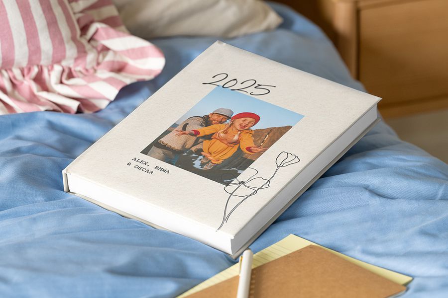 Personalised Photobox year-in-review book showing a father and daughter, providing inspiration for family photo album captions and photobook quotes to capture the year's best moments.