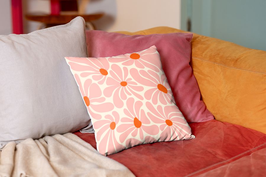 A personalised pink floral cushion on a sofa, representing a renter-friendly living room makeover and bespoke soft furnishings with Photobox.