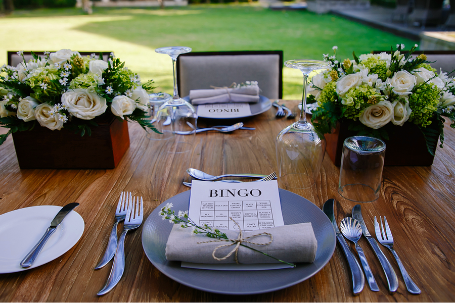 Wedding bingo cards set up on a decorated wedding table with flowers, inspiring Photobox wedding bingo and wedding table games for guests.