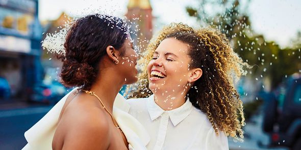 A smiling couple on their wedding day, inspiring ideas for what to write in a wedding card and heartfelt wedding card messages.