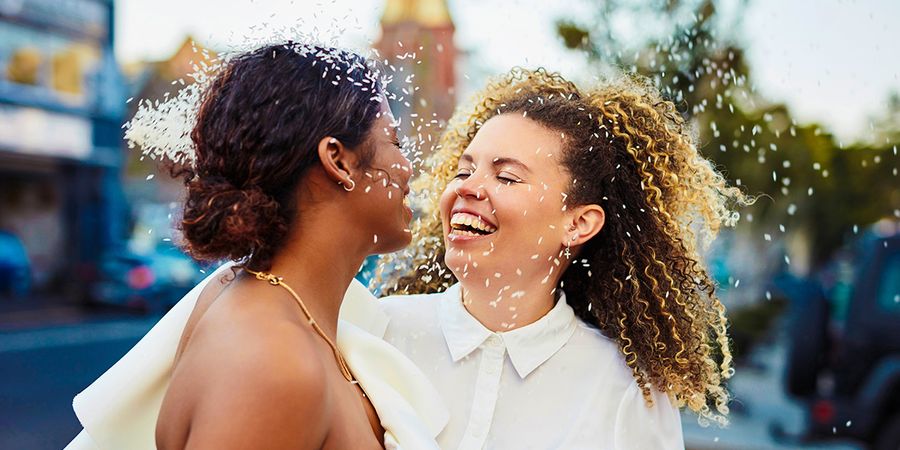 A smiling couple on their wedding day, inspiring ideas for what to write in a wedding card and heartfelt wedding card messages.