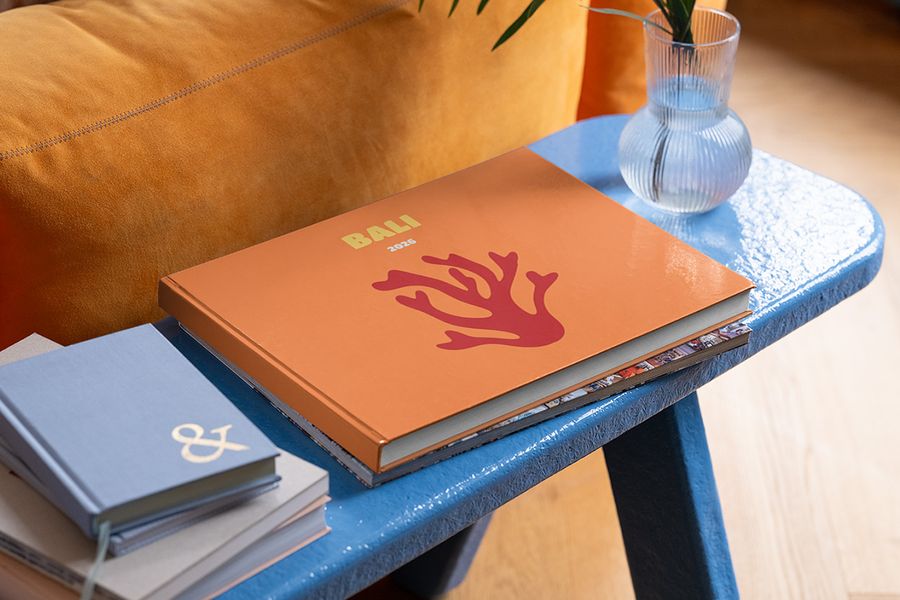 A landscape personalised Photobox travel photo book for Bali sits on a blue coffee table, inspiring summer coffee table decor and finishing touches for your summer home design.