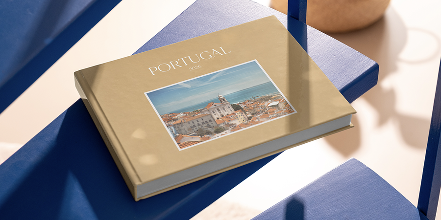 A personalised Photobox family photo book labelled Portugal 2026 sits on a table, capturing family holiday memories and inspiring ways to remember a family trip.