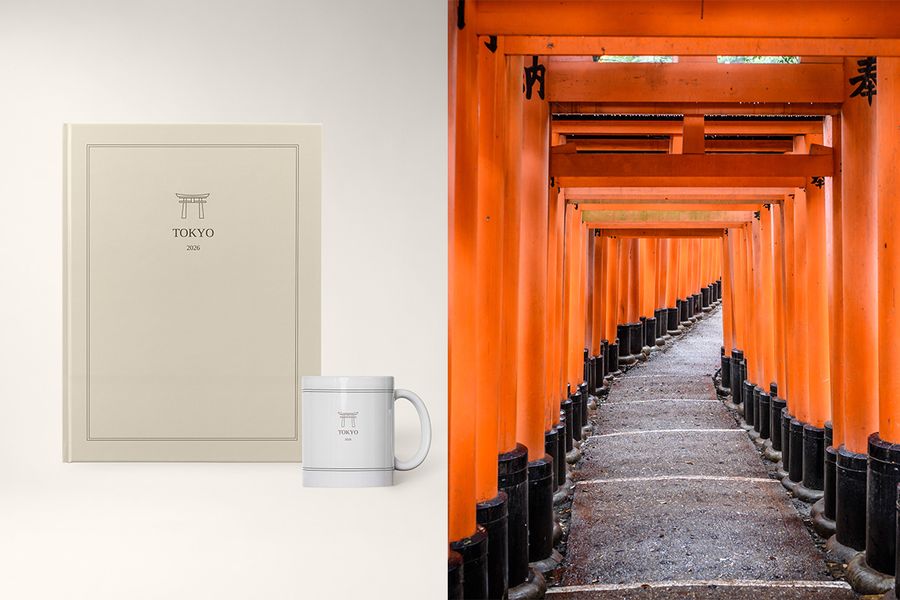 A photo book and mug titled 'Tokyo' sit next to an image of orange shrines in Japan, showcasing Photobox's Archive Edit design with clean layouts and subtle cover illustrations.