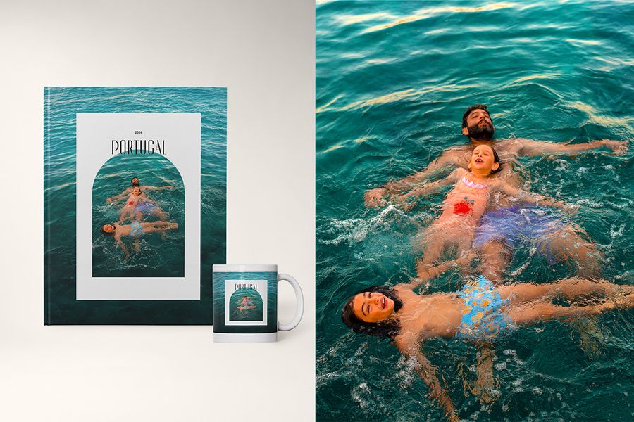 A photo book and matching mug in the Open Arch design from Photobox, featuring a father and two sons playing in the water, framed with soft arch-shaped borders.