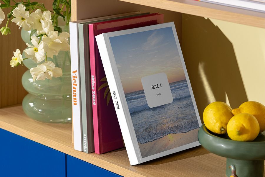 The new Photobox Modern Travelogue photo book sits on a shelf, showcasing clean layouts and elegant typography inspired by travel magazines and coffee-table books.