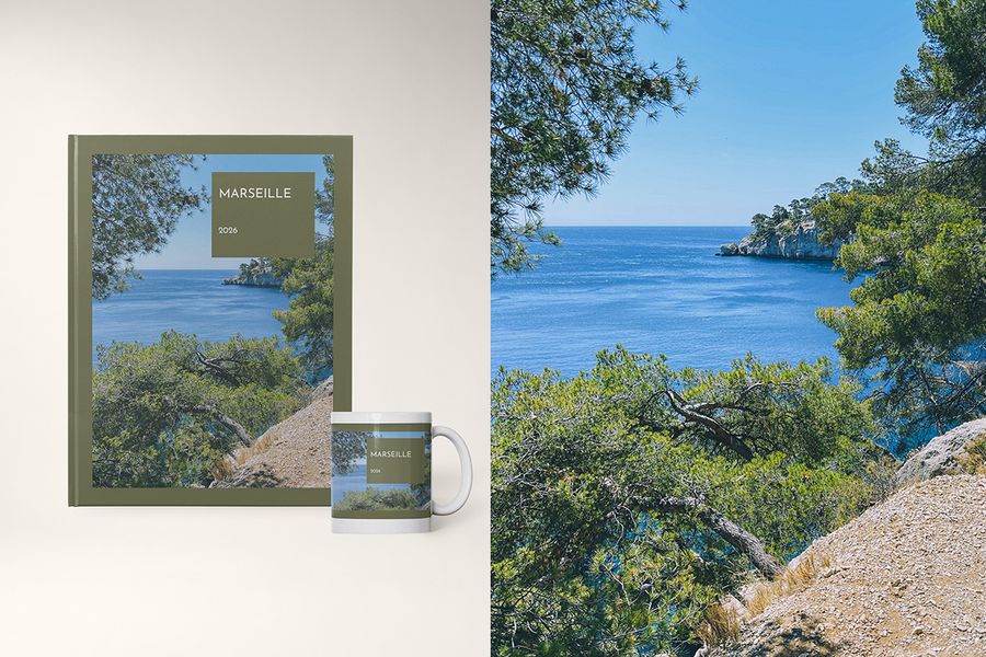 A photo book and mug in the Travel Hues design from Photobox, featuring bold colour blocks inspired by destination palettes like Spain's terracotta tones and Norway's cool blues.