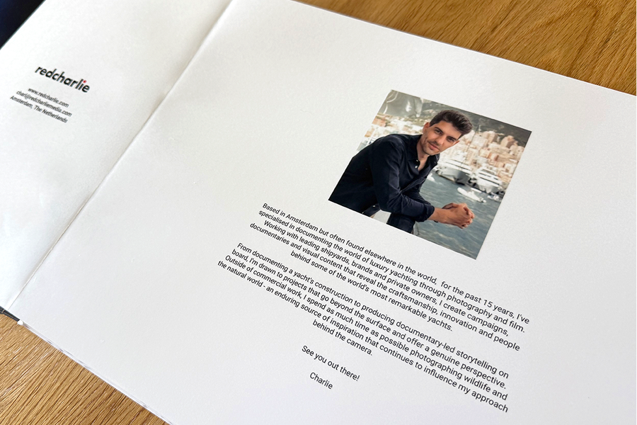 An open spread from Charl van Rooy's photo book shows the opening page with a portrait of him and an introduction to his photography style, illustrating Photobox's tips for structuring a photography portfolio.
