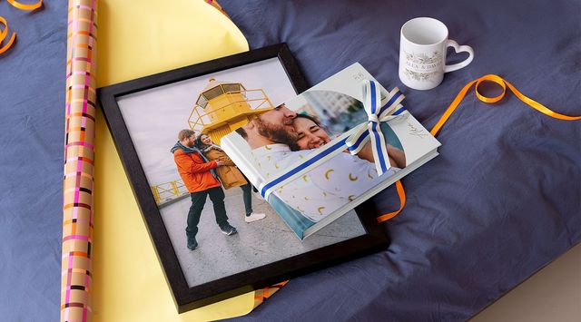 Personalised Photobox anniversary presents: a photo book, a heart-handle mug and a framed canvas.