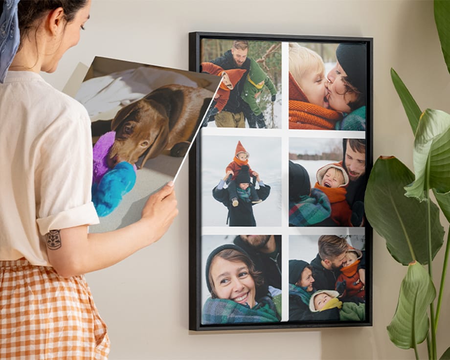 A woman smiling while holding a wall art next to a collage canvas.