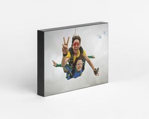 A photo block featuring an image of two people skydiving