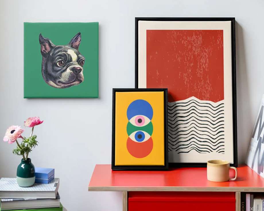 Three pieces of abstract Photobox wall art beside a stack of records in a stylish modern living room, inspiring modern wall art design ideas.