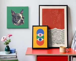 Three pieces of abstract Photobox wall art beside a stack of records in a stylish modern living room, inspiring modern wall art design ideas.