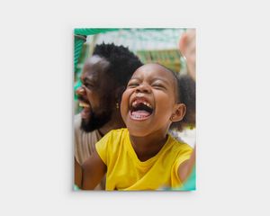 Mounted print of a laughing child.